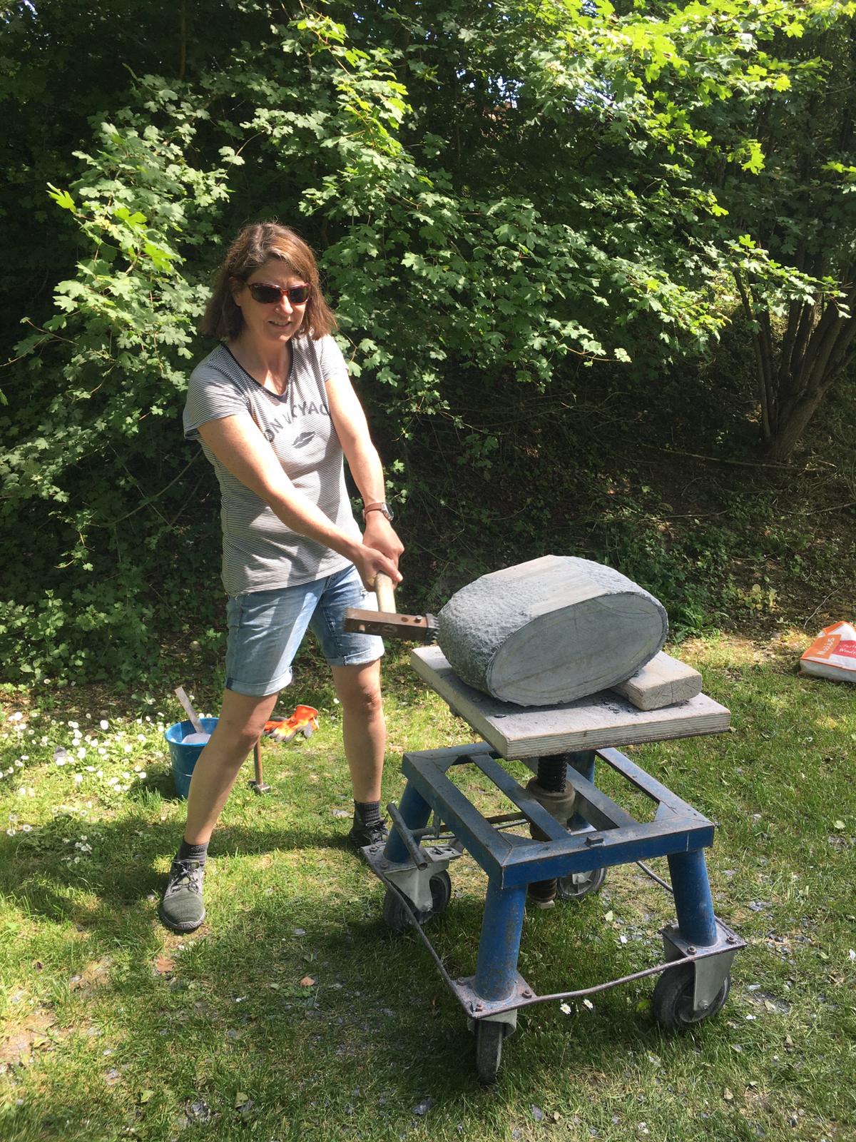 Linda working on a stone sculpture